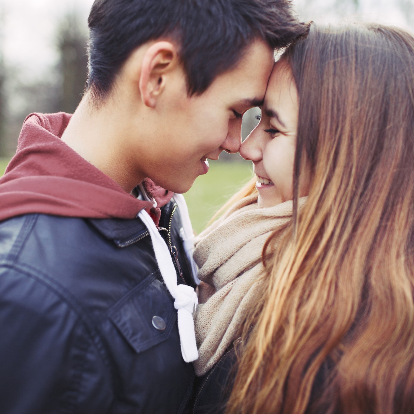 Close up of teenage couple with foreheads touching