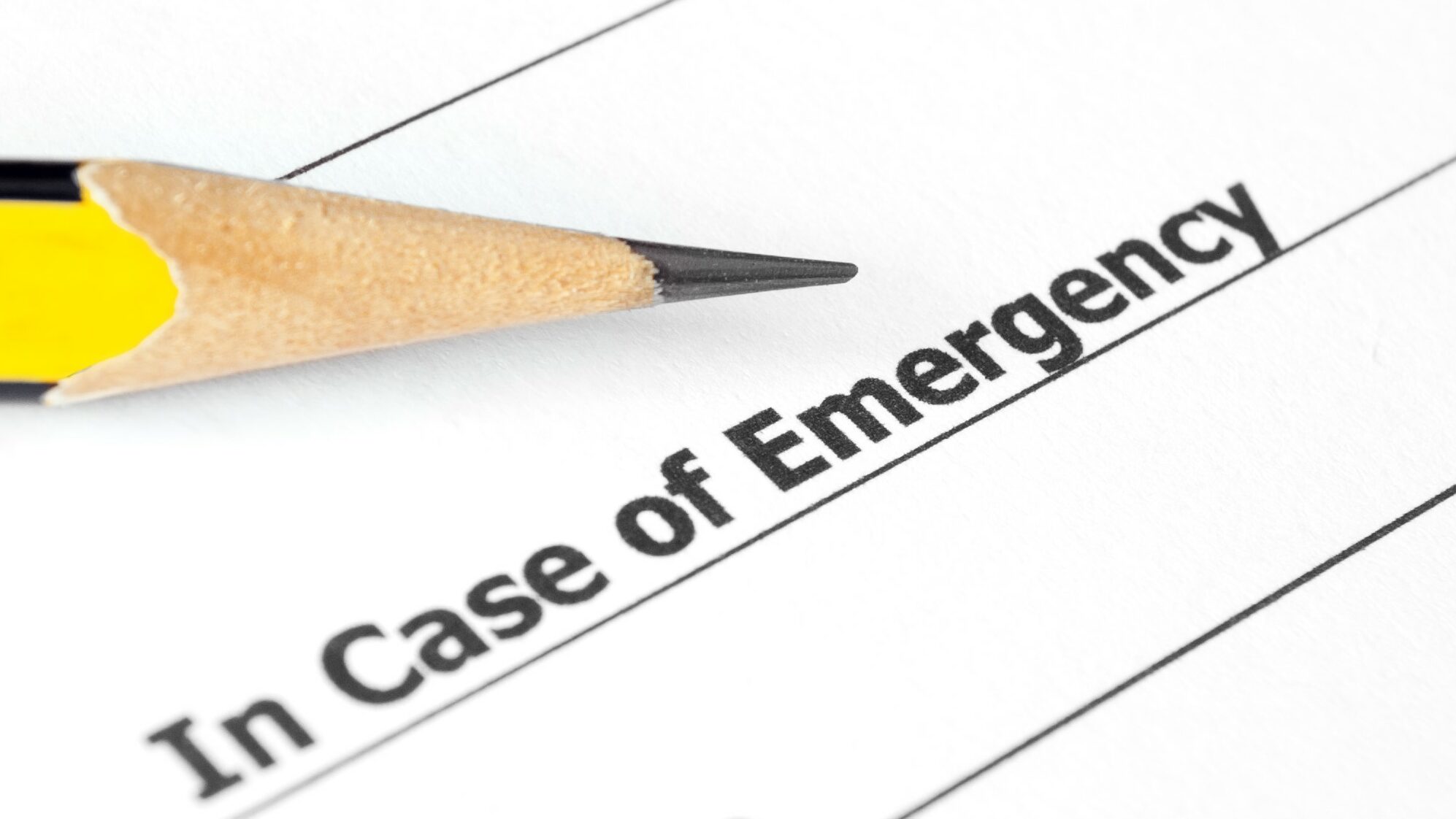 Close-up of Emergency document with pencil