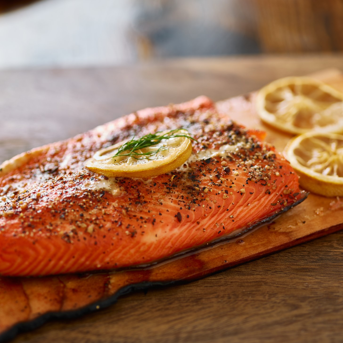 Cooked cedar planked salmon with lemon and dill meal
