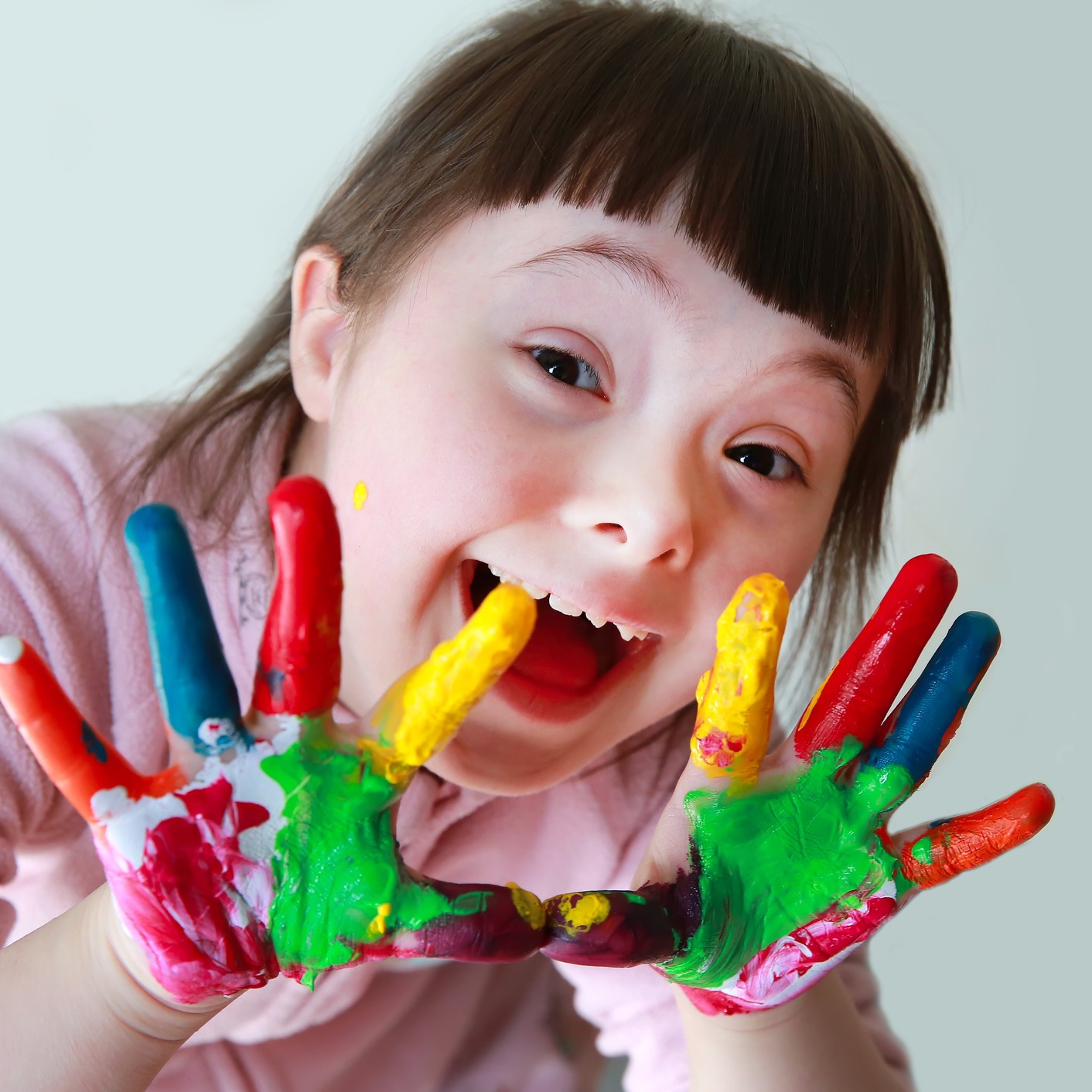 Cute little girl with painted hands.